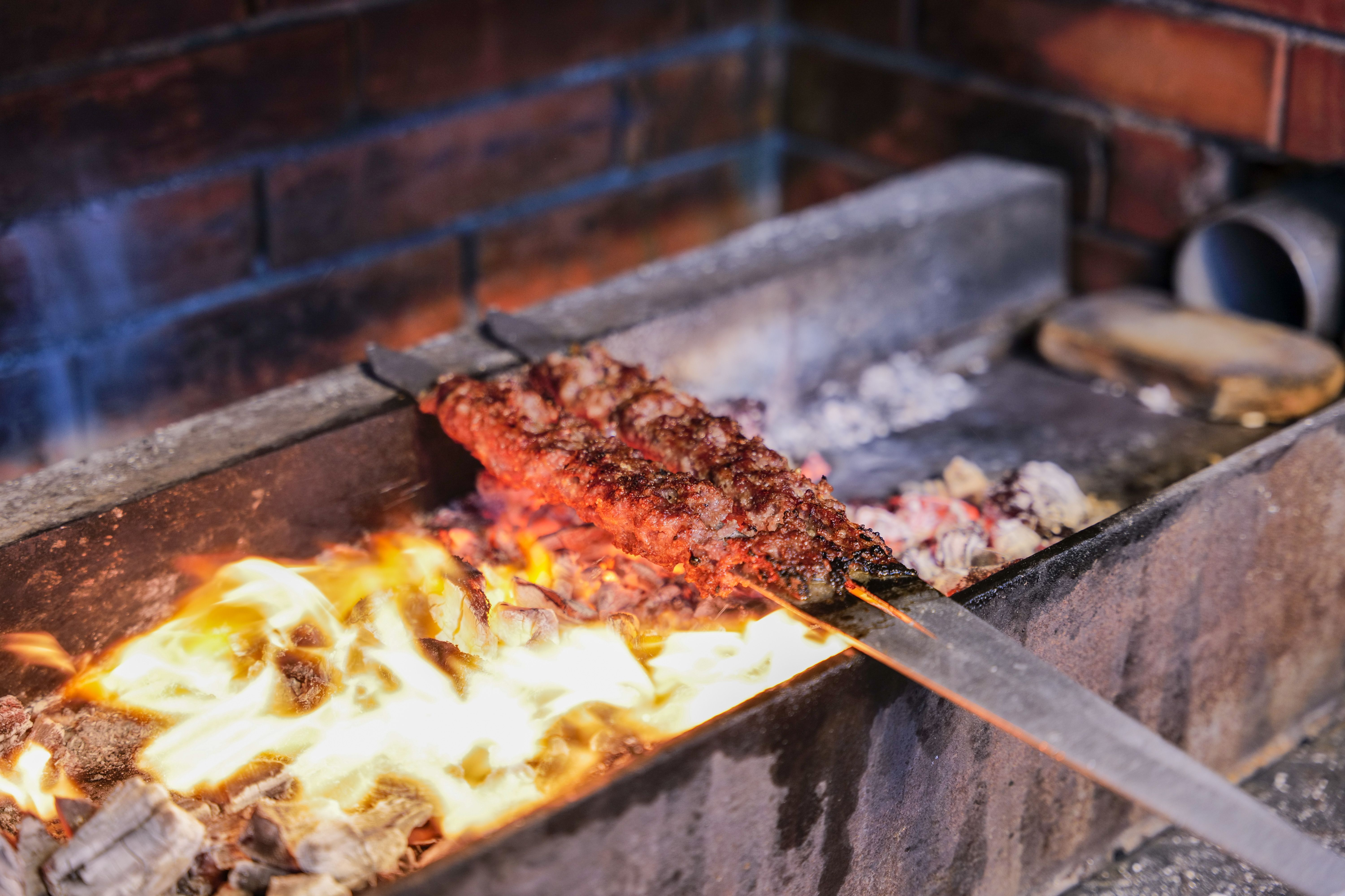 Chef plating food on the charcoal grill